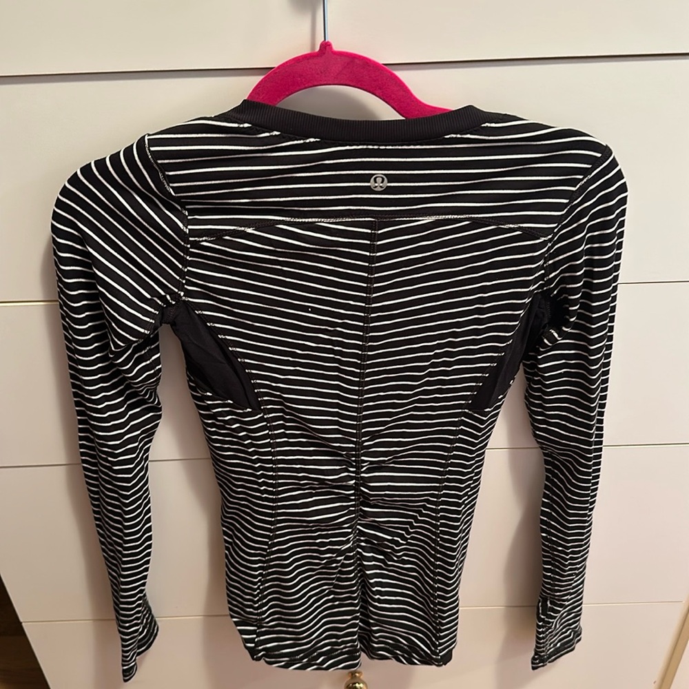 Lululemon on long sleeve exercise top. Breathable material in armpits into back.